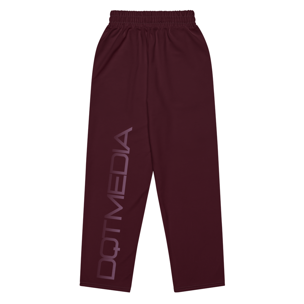 The joggers feature a deep burgundy color and a wide-leg design, providing both style and comfort. They are adorned with the text "DQT MEDIA," which is printed in a bold font against a crisp white background, creating a striking contrast that enhances the overall look. The combination of the rich burgundy and the bright white adds an eye-catching element to these joggers, making them a standout piece for casual outfits.