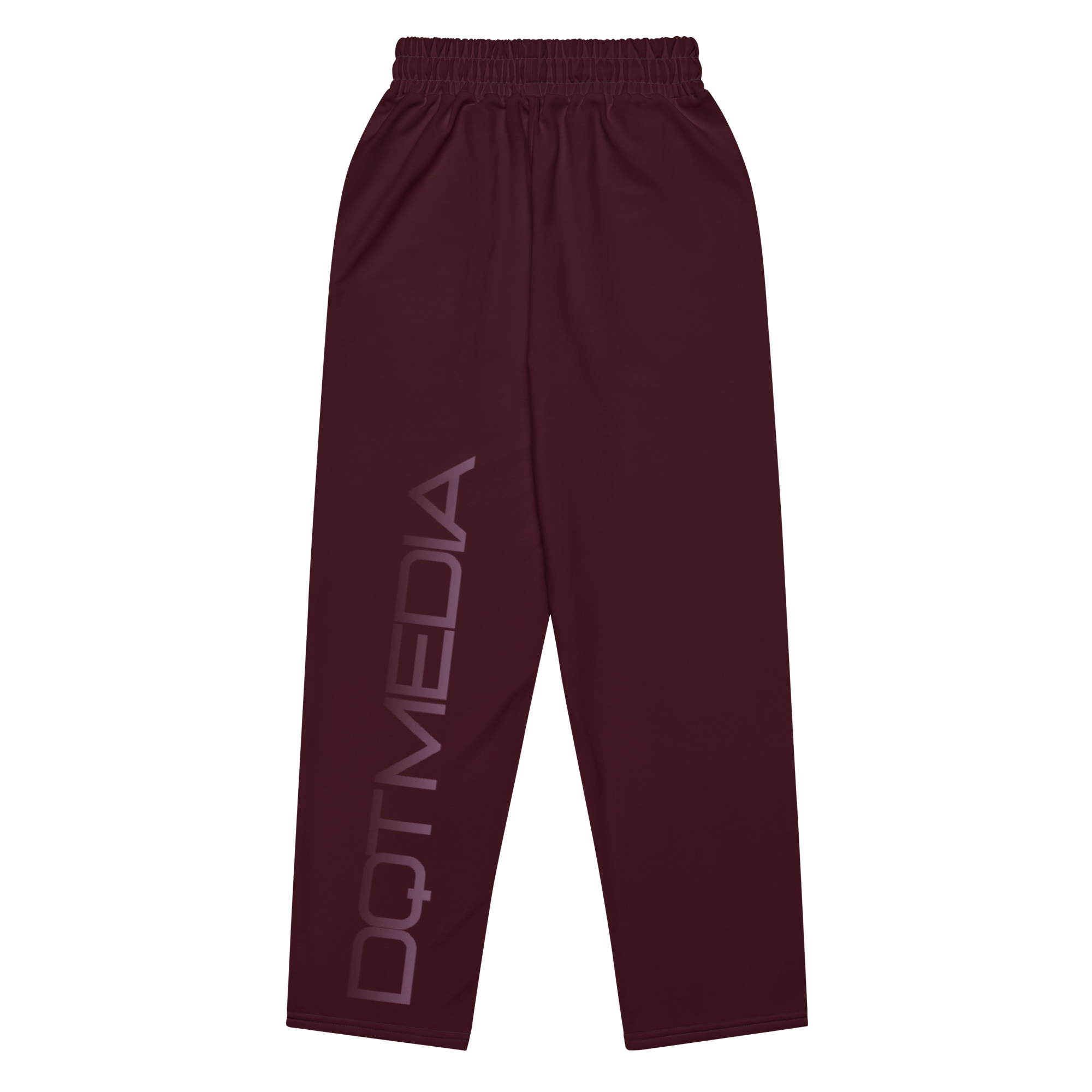The joggers feature a deep burgundy color and a wide-leg design, providing both style and comfort. They are adorned with the text "DQT MEDIA," which is printed in a bold font against a crisp white background, creating a striking contrast that enhances the overall look. The combination of the rich burgundy and the bright white adds an eye-catching element to these joggers, making them a standout piece for casual outfits.